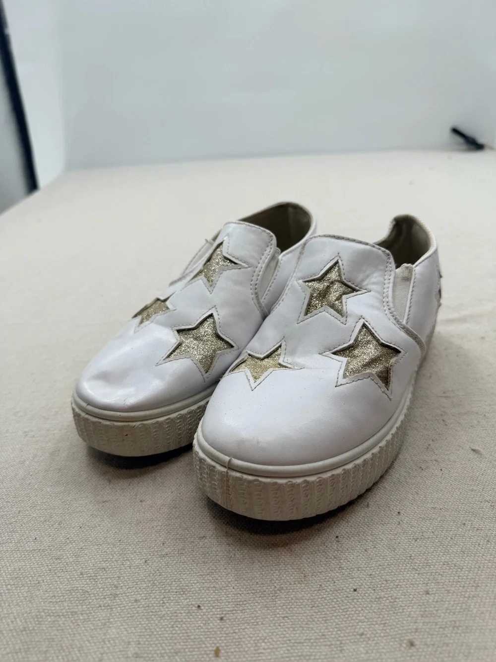 ' White Slip-On Sneakers with Gold Star Accents
